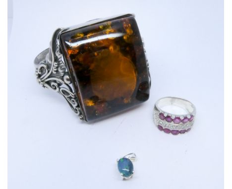 Large Baltic amber modern silver bangle, silver and ruby dress ring and a small silver and blue stone pendant 