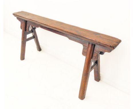 A small 19th century well-patinated bench: the rectangular (possibly fruitwood)&nbsp;top above a four-splay patinated pine ba
