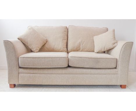 A modern oatmeal-upholstered two-seater sofa with cushions. (166 x 92 x 89 cm)