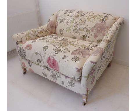 A modern floral upholstered sofa of small and deep proportions (126 x 105 x 78 cm)