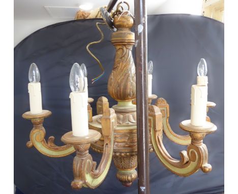 A large and heavy light-green painted and burnished gilt carved wood six-light chandelier of impressive looks and proportions