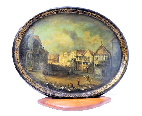 A Victorian hand-painted oval papier-mâché&nbsp;tray: decorated with a town scene and with inlaid mother of pearl and gilt bo