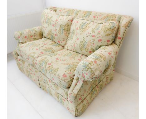 A modern two-seater floral upholstered sofa (145 x 97 x 88 cm), matching curtains lot 345A