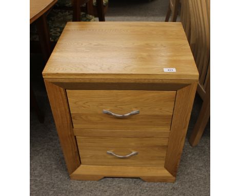 A pair of good quality modern light oak two drawer bedside chests