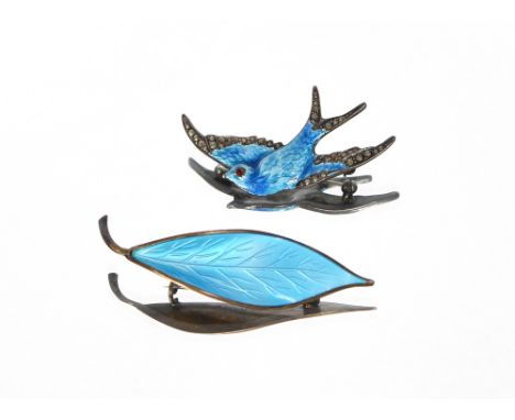 A white metal blue enamel and marquisette decorated swallow brooch; and a 925 and enamel decorated leaf brooch