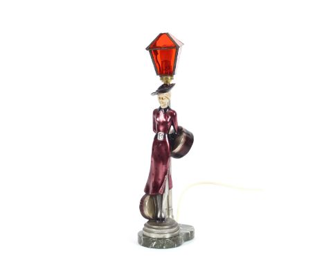 An Art Deco design table lamp, in the form of a lady standing beside a street lamp, 45cm high