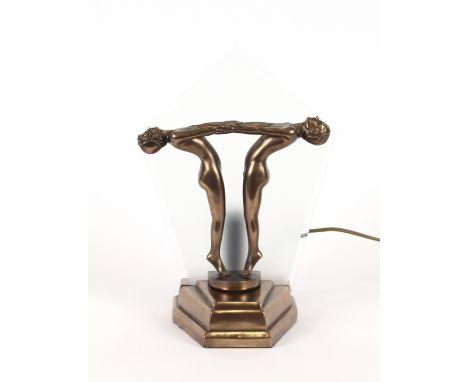 An Art Deco design table lamp, in the form of two naked dancing girls on a stepped base, 29cm high