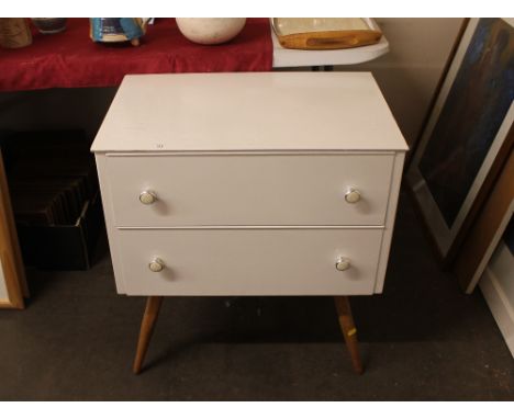 A pair of 1960's white painted two drawer  bedside chests, raised on light wood tapering supports, 62cm  
