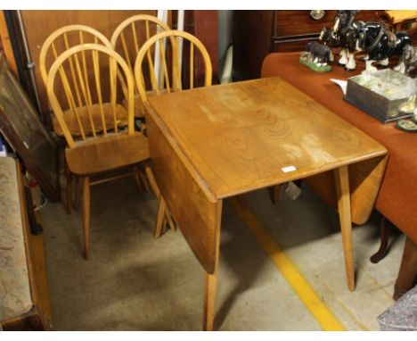 An Ercol drop leaf kitchen table, and four Ercol stick back chairs 