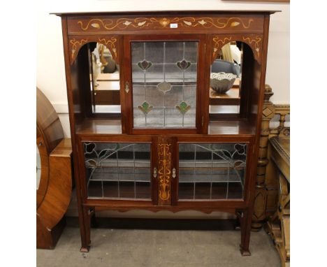 An Art Nouveau mahogany and inlaid display cabinet in the manner of Shapland &amp; Petter fitted with mirrored shelves, fabri