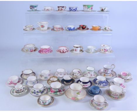 Collection of miniature cups and saucers including; Coalport, Spode, Royal Crown Derby, Royal Worcester, Wedgwood, Masons and