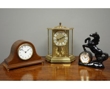 Edwardian inlaid mahogany dome top mantle clock with brass feet, glazed and gilt metal torsion clock and ceramic black horse 