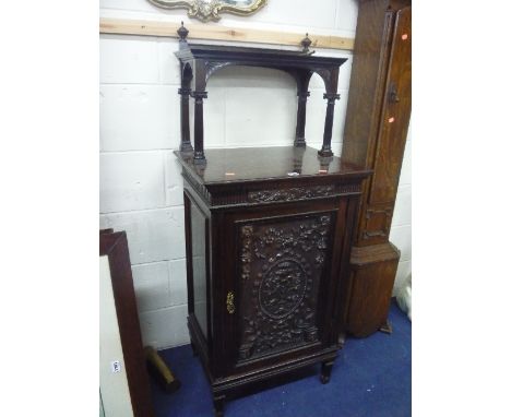 A 19TH CENTURY CARVED ROSEWOOD SINGLE DOOR CABINET, with raised upper shelf