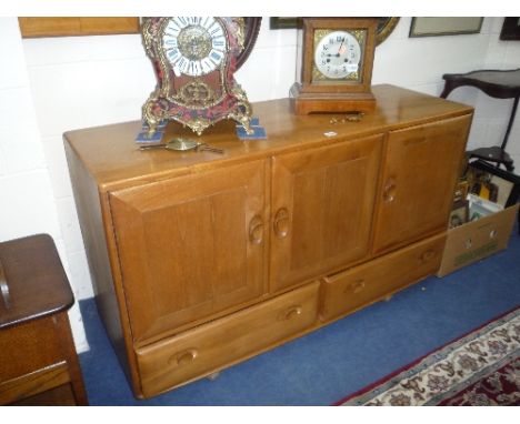 AN ERCOL BLONDE ELM SIDEBOARD, with triple doors above twin lower drawers