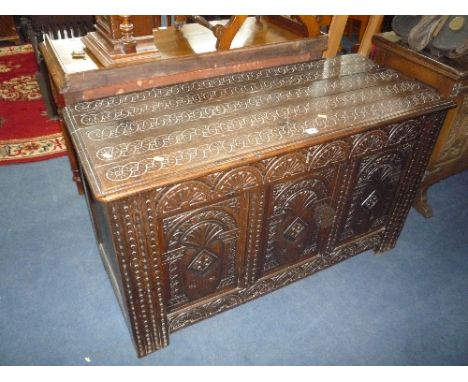 A 19TH CENTURY AND LATER CARVED OAK TRIPLE PANEL BLANKET CHEST