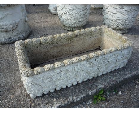 A RECTANGULAR CONCRETE GARDEN PLANTER