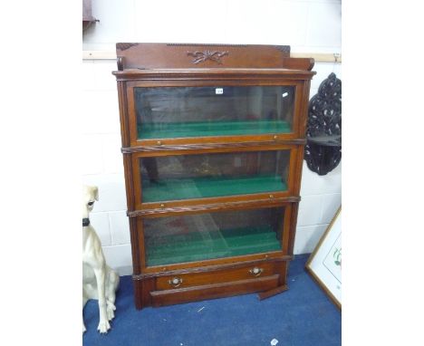 A WALNUT GLOBE WERNICKE STYLE THREE SECTION BOOKCASE, with lower drawer (s.d.)