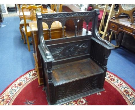 A VICTORIAN CARVED OAK MONKS BENCH, (upper section has been cut down)