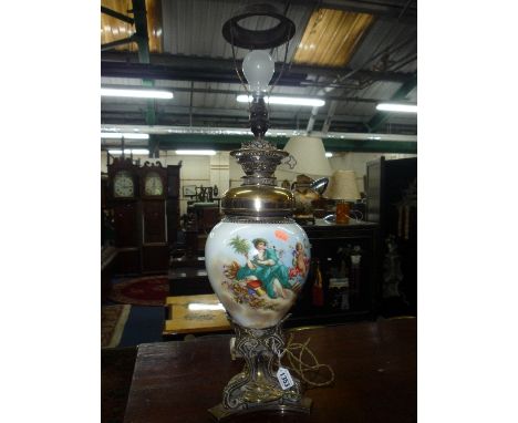 A 19TH CENTURY CERAMIC OIL LAMP BASE, decorated with classical scene, brass base and fitments (converted to electricity, silv