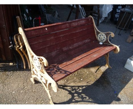 A GARDEN BENCH, with painted cast iron ends