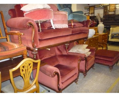 AN UPHOLSTERED FOUR PIECE LOUNGE SUITE, with wooden frame comprising of a three seater settee, a pair of armchairs and a pouf