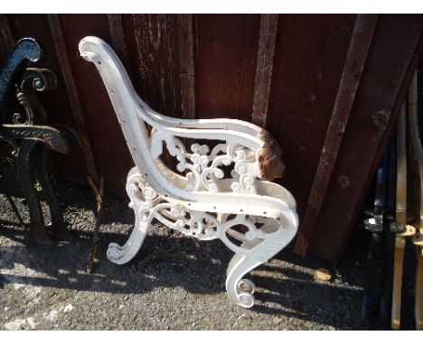 A PAIR OF PAINTED CAST IRON BENCH ENDS, with lions mask detail