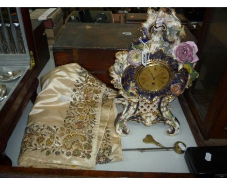 A FLORALLY ENCRUSTED PORCELAIN MANTEL CLOCK, (with key and pendulum) (s.d.) and a embroidered table runner (2)