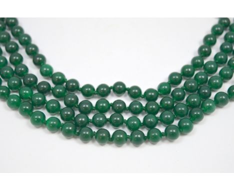 A JADE NECKLACE, comprising of four strands of jade beads, to the white metal clasp (jade possibly dyed) length 46cm