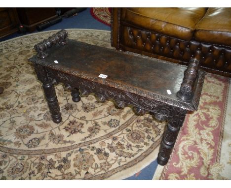A SMALL VICTORIAN CARVED OAK BENCH / WINDOW SEAT