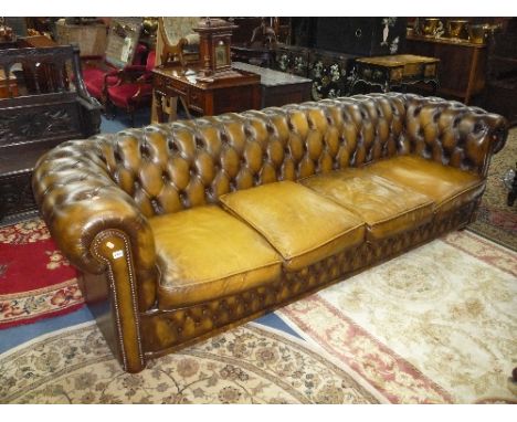 A LARGE LEATHER BUTTONED CHESTERFIELD FOUR SEATER SOFA