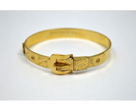 A BANGLE, with buckle design operating as the clasp, diameter 6cm