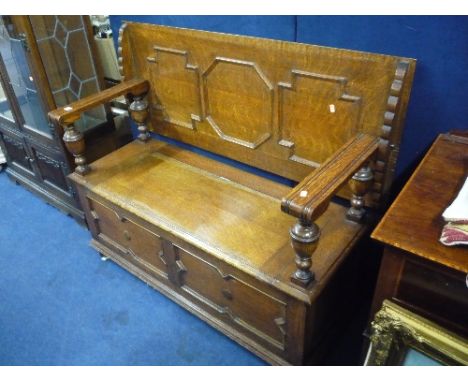 A LARGE OAK MONKS BENCH