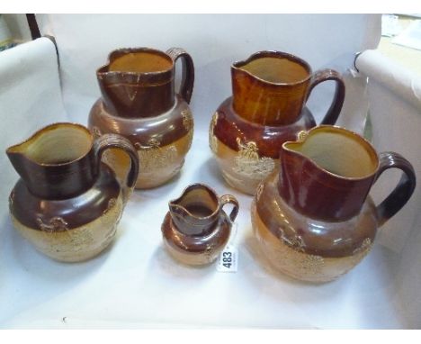 FIVE DOULTON LAMBETH SALT GLAZED JUGS, of various sizes, Hunting scenes, impressed marks