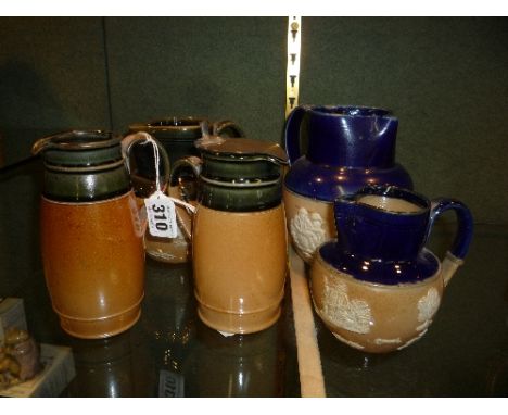 TWO ROYAL DOULTON SALT GLAZED JUGS, impressed marks, one with fitted metal lid, height approximately 14cm and three Doulton h