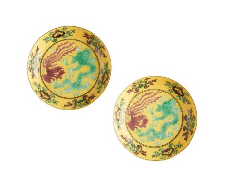 PAIR OF YELLOW-GLAZED SAUCERS XUANTONG MARK AND POSSIBLY OF THE PERIOD   宣統款或到代 黃地綠彩龍紋及褐彩鳳紋盤一對 each finely painted on the int