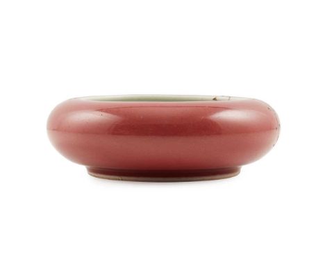 RED-GLAZED BRUSH WASHER KANGXI MARK   康熙款 紅釉鏜鑼洗 of compressed globular form with an inverted mouth, the exterior covered in r