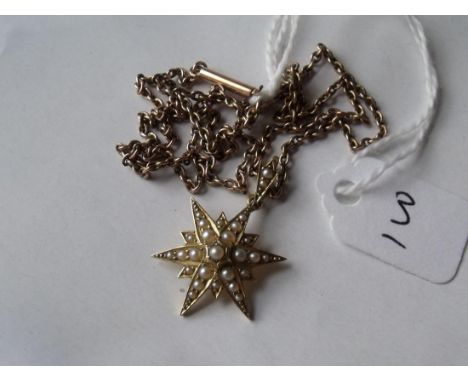A gold mounted pearl starburst pendant on gold chain dated 1910