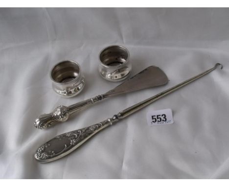A pair of circular salts a shoe horn and button hook   