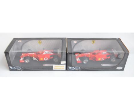 Two 1/18 scale diecast Michael Schumacher Collection F1 Ferrari F2001 models from Hot Wheels Racing with seated driver figure