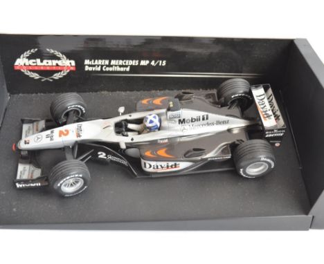 Two 1/18 scale diecast F1 David Coulthard McLaren Mercedes models from Minichamps/Paul's Model Art with seated driver figures