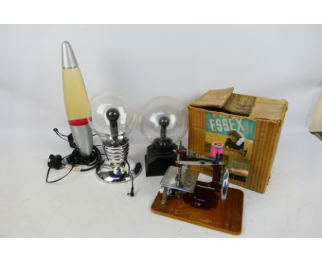 Lot to include a lava lamp, a light bulb form table lamp and a boxed Essex Miniature Sewing Machine. [2]. [W]