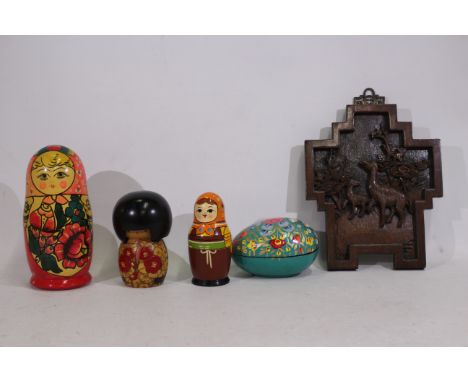 An assortment of items to include  2 x Russian nesting dolls, both containing 7 x inner pieces. A wall-piece wooden carving. 