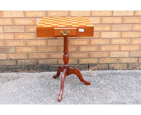 A chess / draughts board table with draughts pieces, approximately 63 cm x 41 cm x 41 cm. [W]