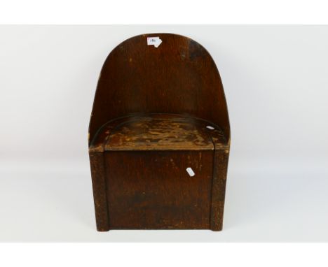 A child's vintage commode with carved decoration, approximately 49 cm (h). [W]