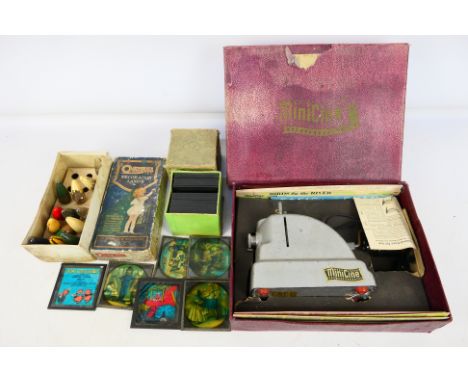 A boxed Minicine projector with a quantity of film strips, a box of Three Little Pigs lantern slides and other. [W]