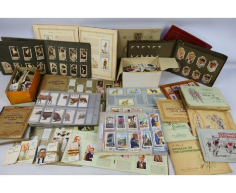 A collection of cigarette card albums to include Dogs, Speedway, Tennis, Naval Craft, Motor Cars, Association Footballers, Un