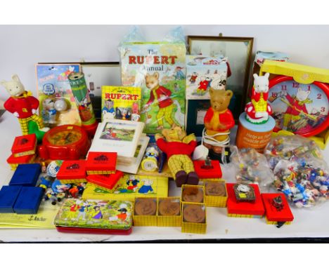 Mixed Rupert The Bear related collectables to include toys, annuals, alarm clock, night light, pictures, figures and other. [
