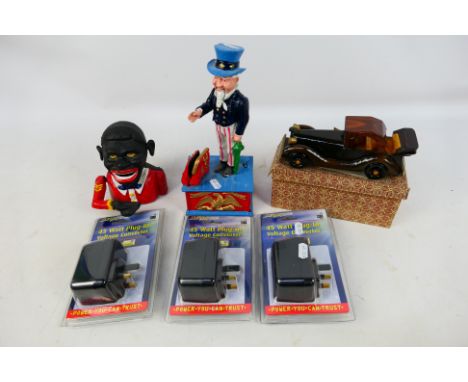Two cast iron mechanical money banks, model car and a quantity of 45 Watt Plug In Voltage Converters. [W]

Note: Mechanical c