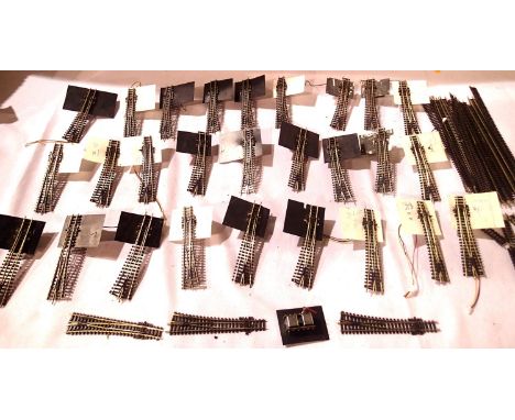 Twenty seven N gauge Peco points fitted with Peco point motors, ex layout, and three other points, one point motor and a sele