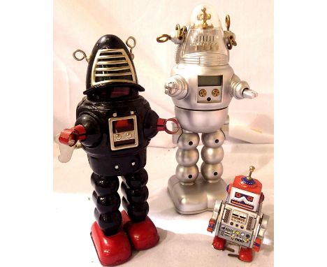 Three toy robots - Black sparking/walking, 23 cms, silver/red walking, 10 cms and silvery battered operated robot sound/light
